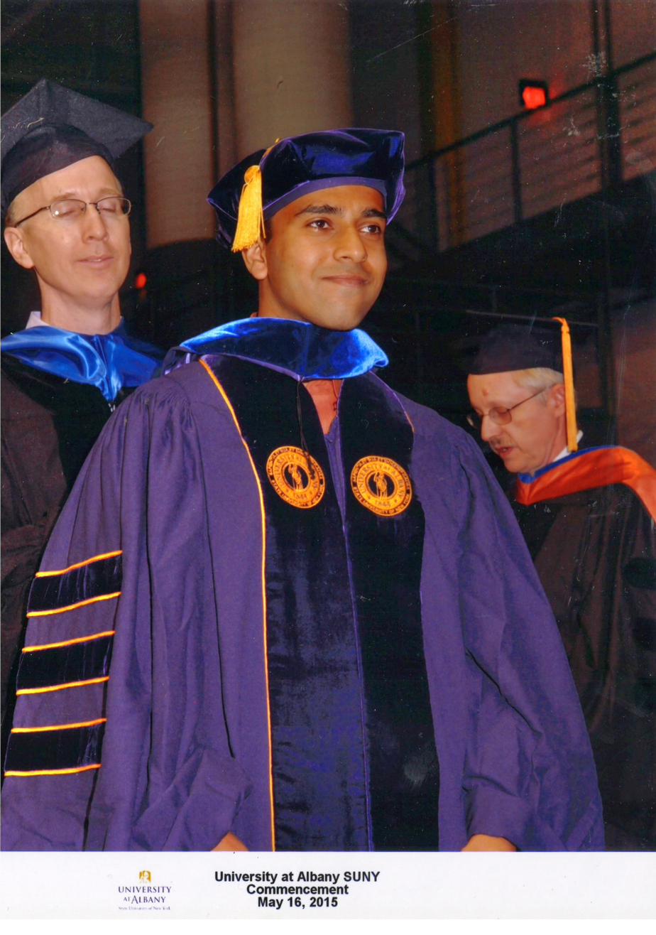 Being hooded at Ph.D. Commencement