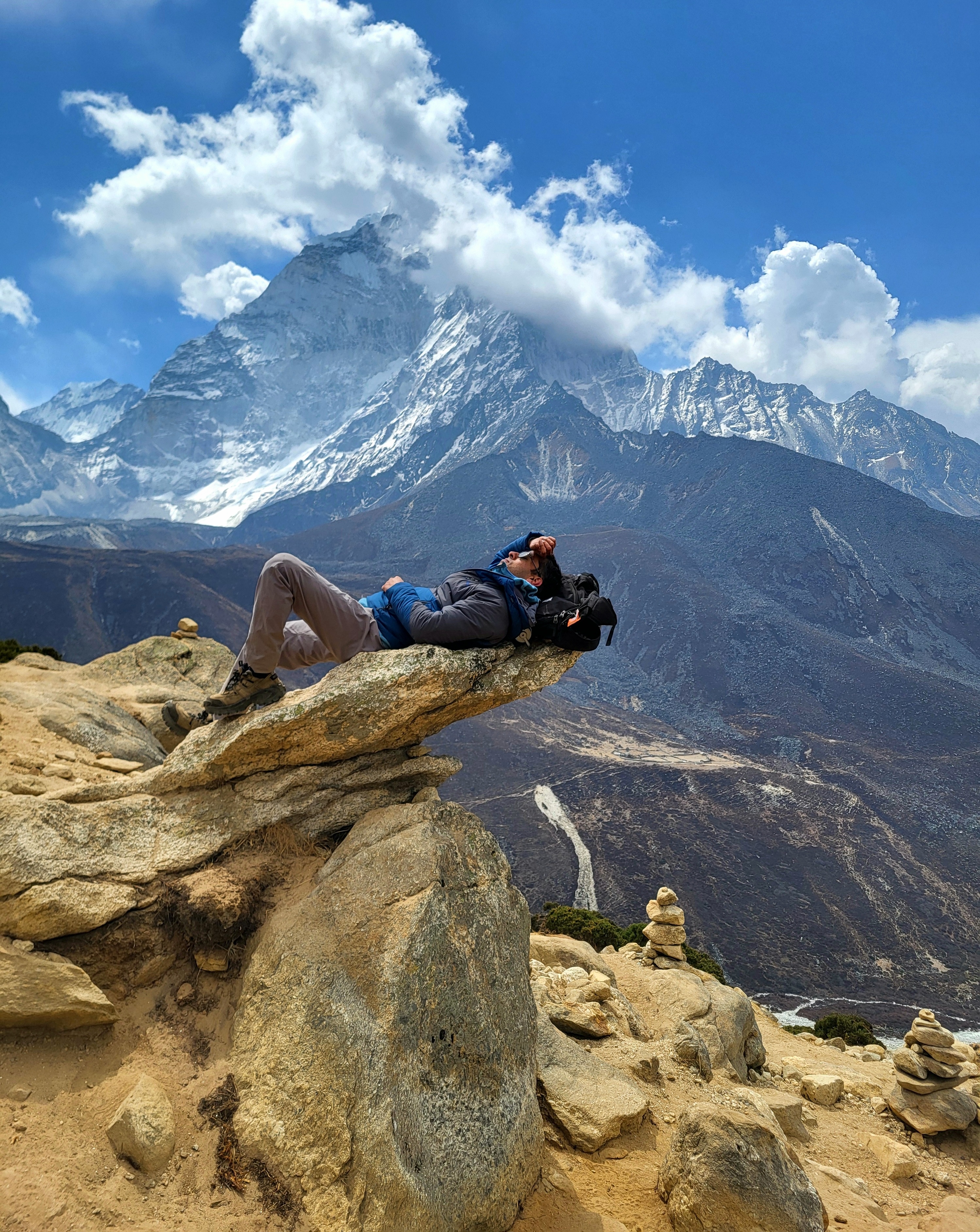 Lying on a rock with Ama Dablam in the background
